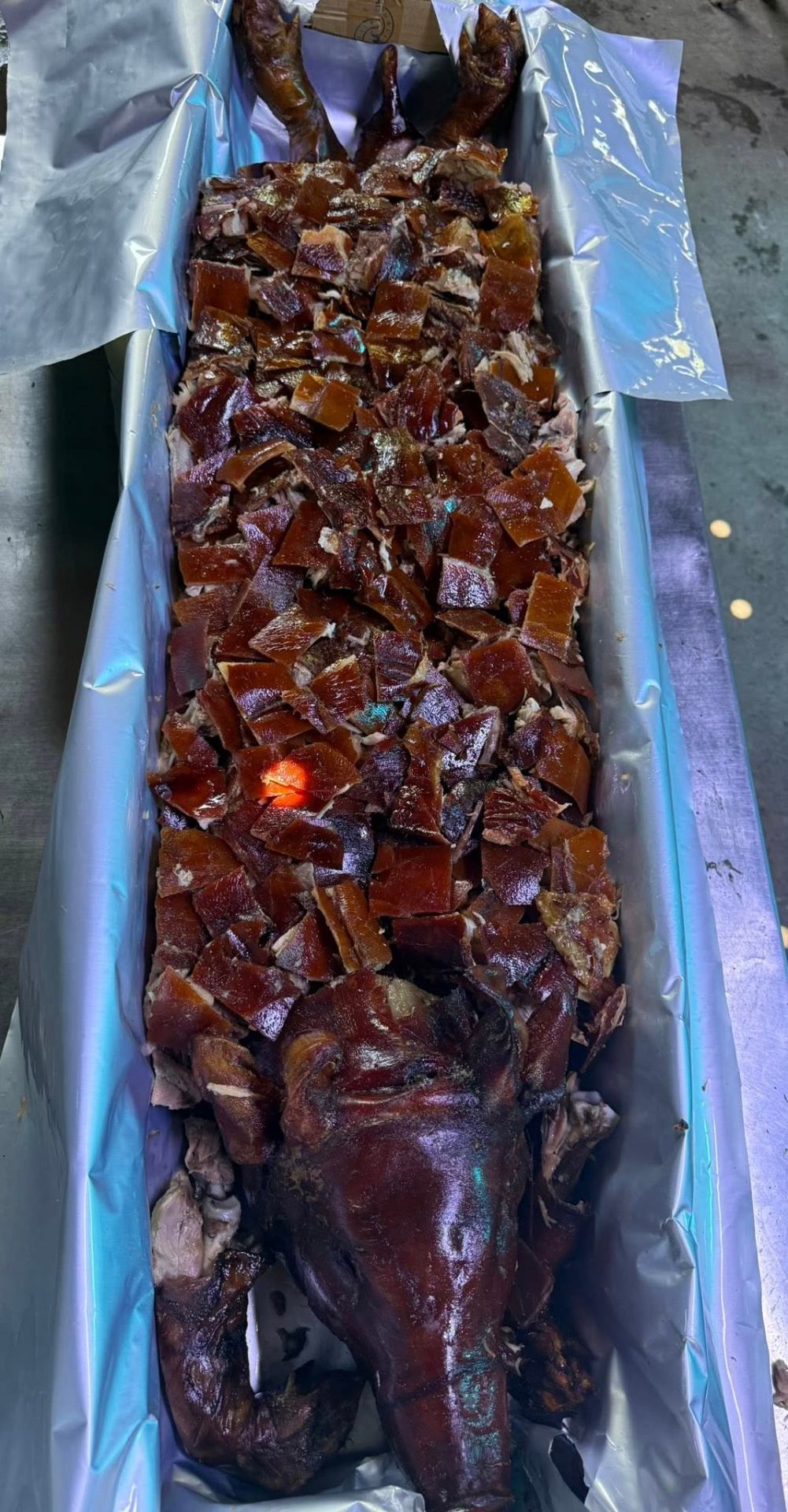 Full lechon with chopped pieces ready to serve